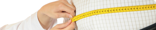 Doctor measuring waist of male patient with tape measure.