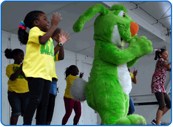 Children jump with Charley the Big Green Rabbit