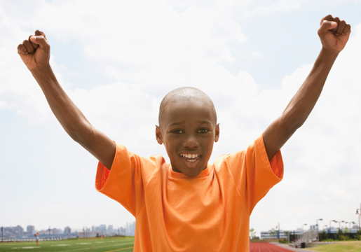 Boy raising arms in the air