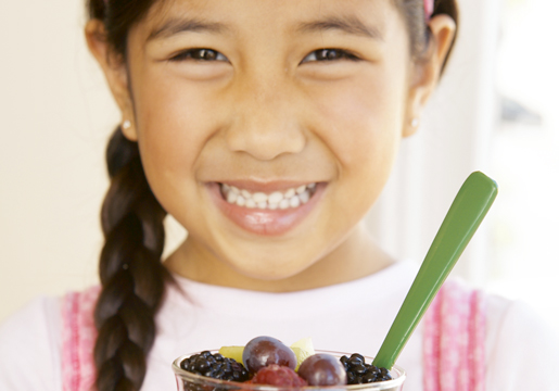 Girl holding fruit cup