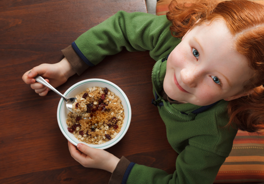 Girl eating bowl of oatmeal