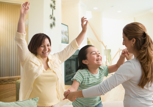 Two women and girl dancing