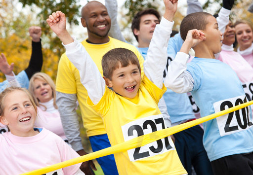 Adults and kids crossing the finish line