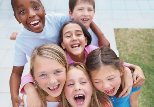 Six children hugging and laughing