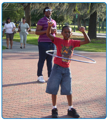 A child in Savannah hula hoops on We Can! Day