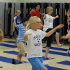 Adults and children doing yoga in a room