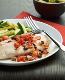 Baked tilapia with tomatoes on a plate